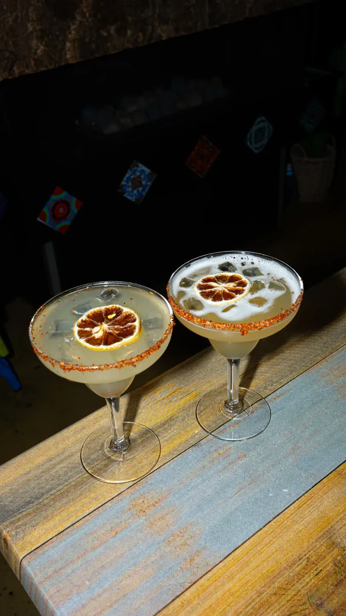 Two margaritas served on the pass